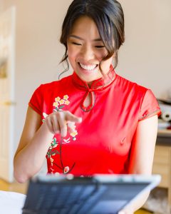 Amy in red cheongsam during the door games before the tea ceremony