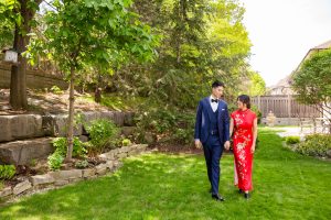 Couple walking hand in hand through a lush garden path