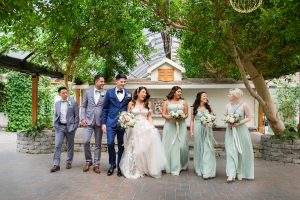 Bridal party posing naturally at Madison Greenhouse