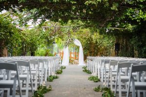 Wedding ceremony under the glass canopy at Madison Greenhouse