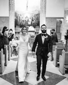 Joyful wedding exit at Saint Clare of Assisi Church captured by Ikonica