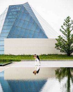 Bride and groom kissing at Aga Khan Museum during their wedding photoshoot in Toronto