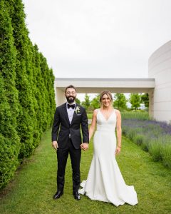 Happy Bride and groom posing at Aga Khan Museum during their wedding photoshoot in Toronto
