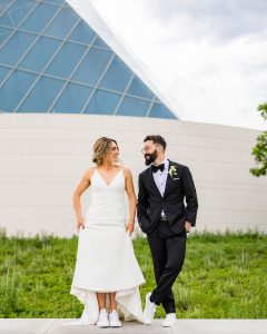 Bride and groom smiling at Aga Khan Museum during their wedding photoshoot in Toronto
