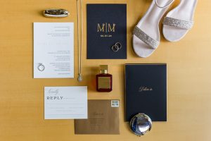 Flat lay of wedding invitation and bride’s accessories