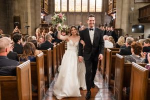 Bride and groom walk down the aisle smiling after their Knox College ceremony.