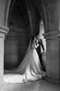 Couple shares a quiet moment by the arched window inside Knox College.
