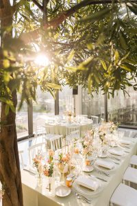 Lush floral arrangements by Jong Young Flower Market decorating the ceremony space at Hotel X Toronto.