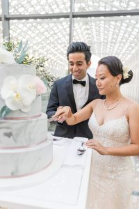 Four-tier wedding cake decorated with fresh florals by Just Temptations at New Fort Hall reception.