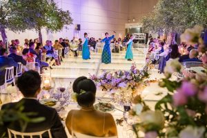 Traditional dance performance at the wedding reception inside New Fort Hall, with guests watching from candlelit tables.
