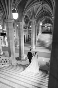 Couple walks hand in hand down the grand staircase at Knox College.