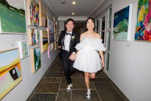 bride and groom running in hallway at Langdon Hall